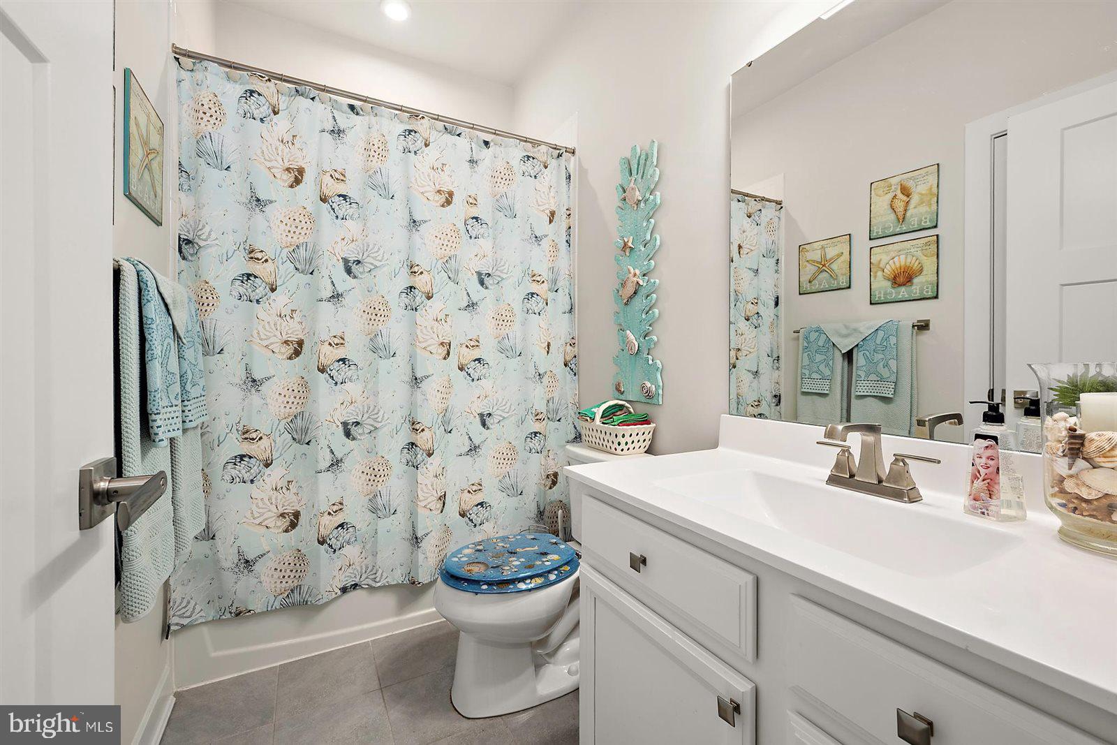 23546 Robalo Road Frankford, DE 19945 - Photo 45 of 78 a bathroom with a sink toilet and shower