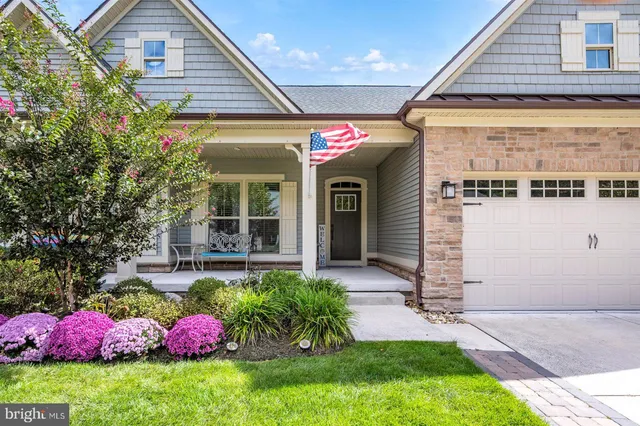 a view of a house with patio and a garden