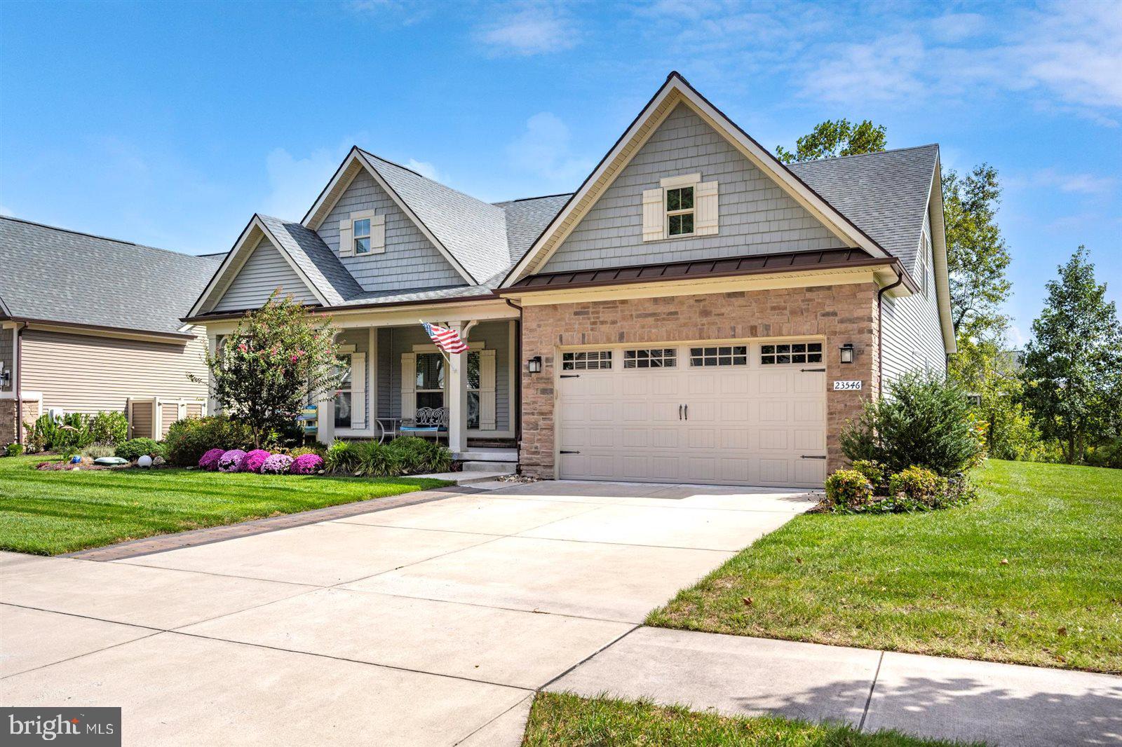 23546 Robalo Road Frankford, DE 19945 - Photo 9 of 78 a front view of a house with a yard and garage