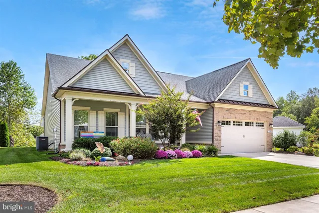 a view of a hallway with wooden floor and closet