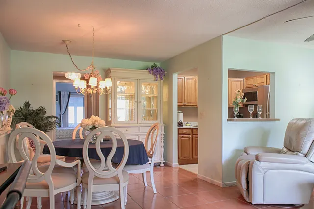 a view of a dining room with furniture and chandelier