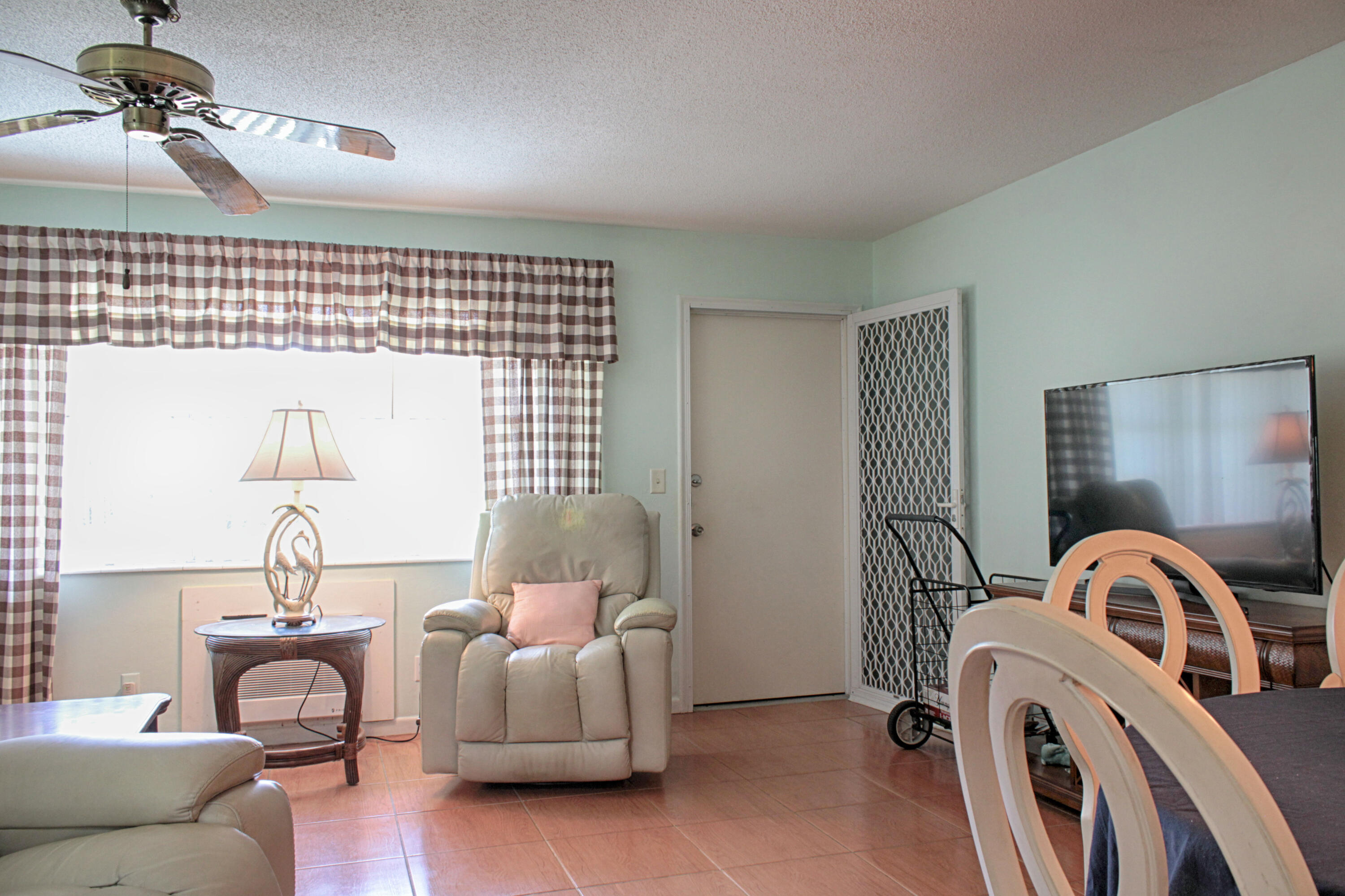 880 Horizon West, Unit 102 Boynton Beach, FL 33435 - Photo 13 of 34 a bedroom with a bed and a chandelier