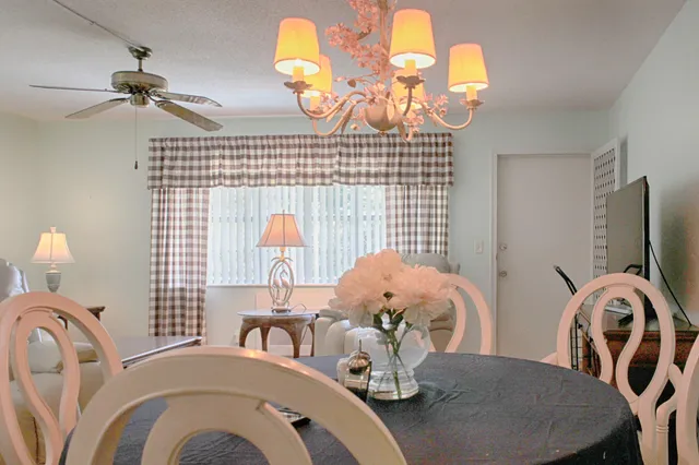 a view of a dining room with furniture and chandelier