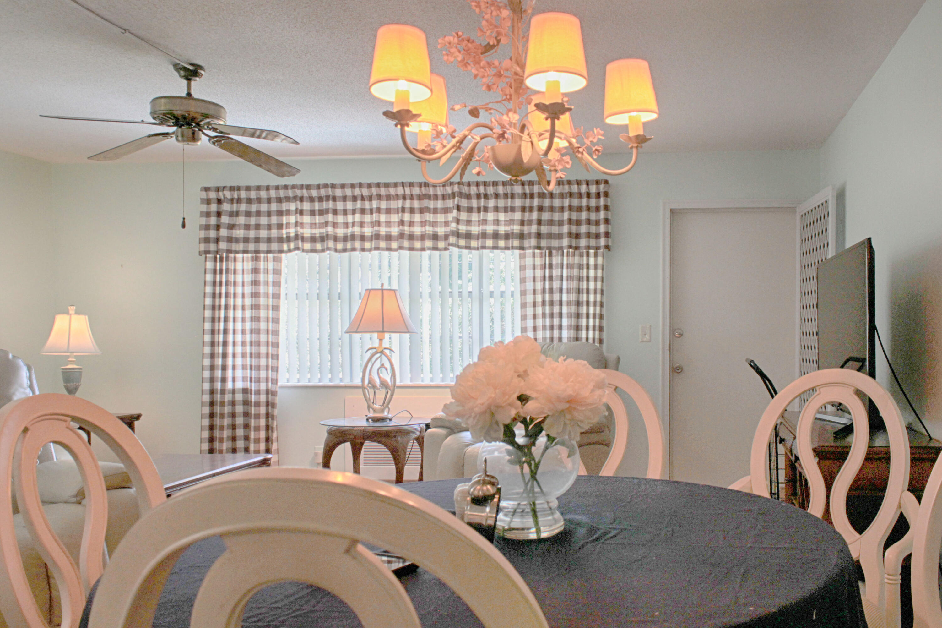 880 Horizon West, Unit 102 Boynton Beach, FL 33435 - Photo 14 of 34 a view of a dining room with furniture and chandelier