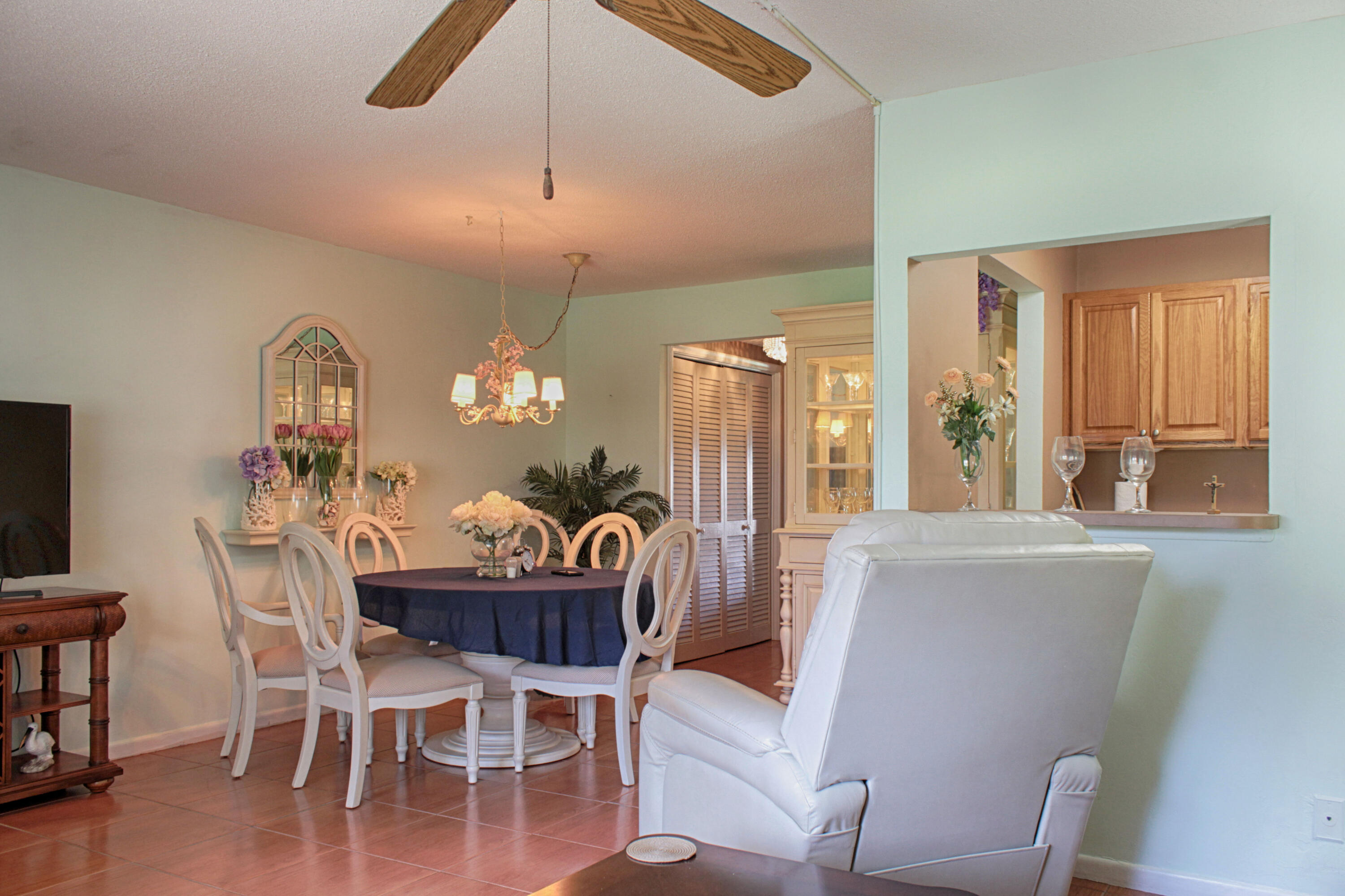 880 Horizon West, Unit 102 Boynton Beach, FL 33435 - Photo 16 of 34 a view of a dining room with furniture window and wooden floor