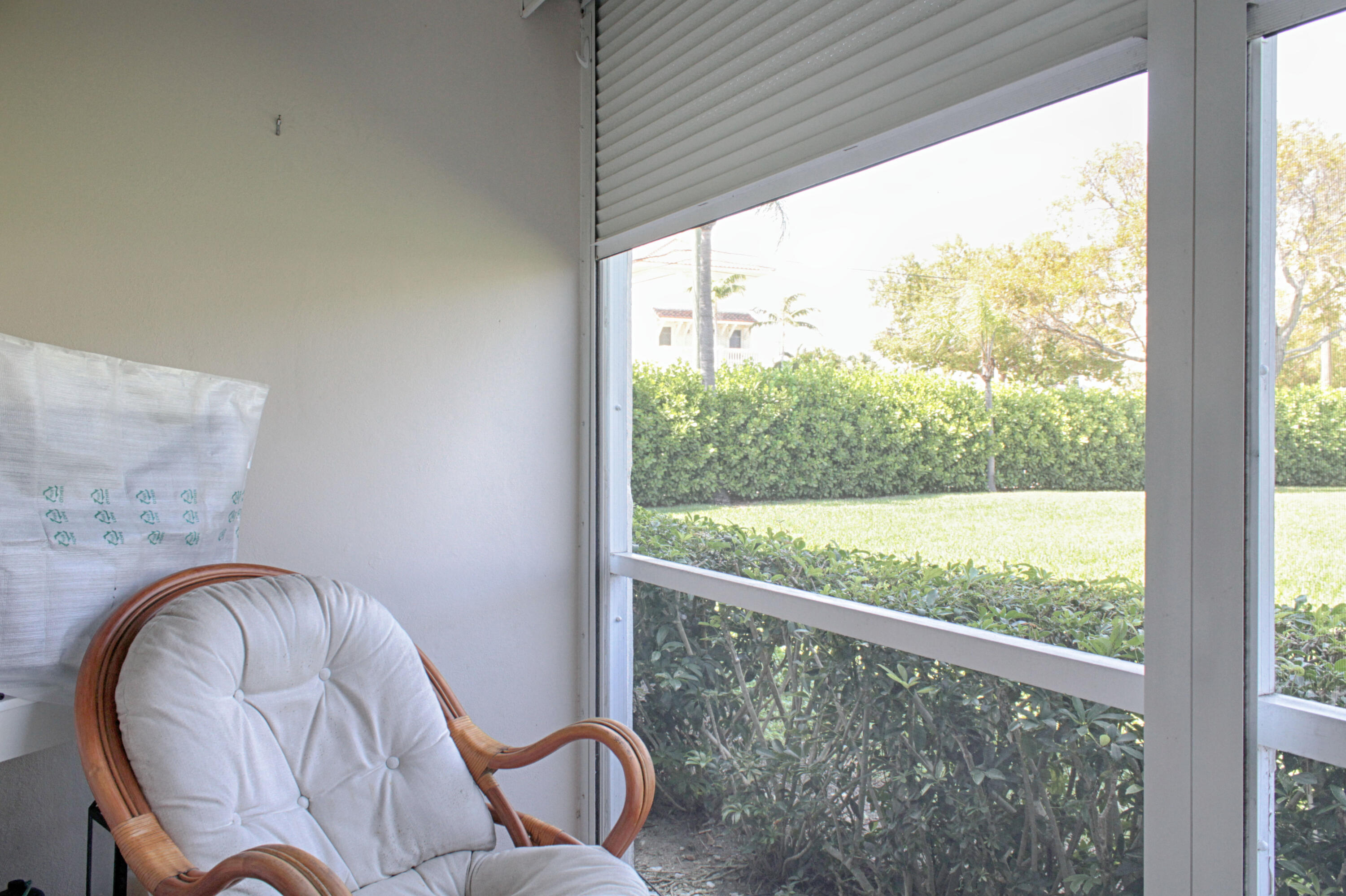 880 Horizon West, Unit 102 Boynton Beach, FL 33435 - Photo 23 of 34 a outdoor room with a large window and chairs