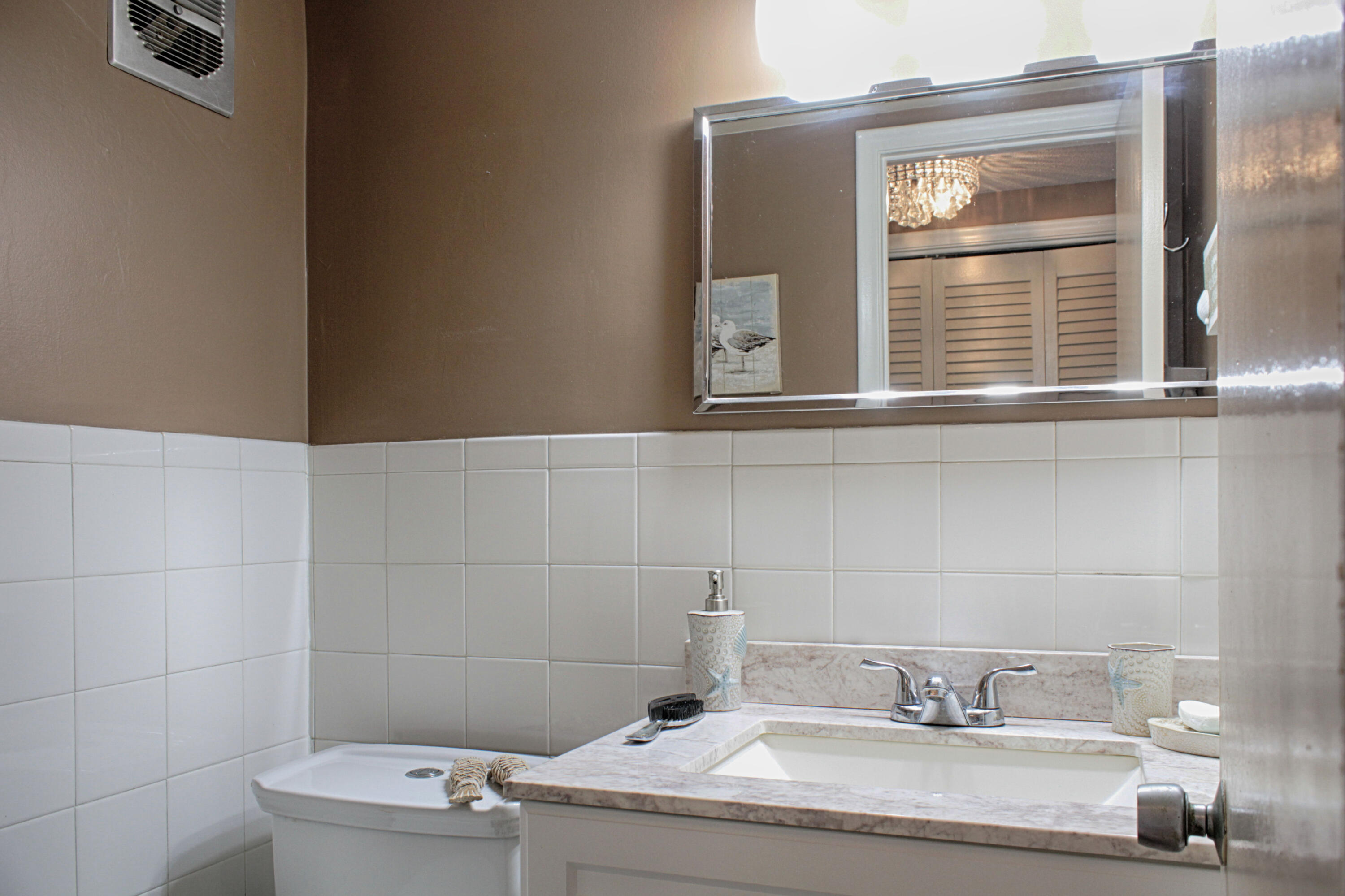 880 Horizon West, Unit 102 Boynton Beach, FL 33435 - Photo 24 of 34 a bathroom with a sink and a mirror