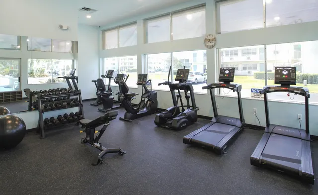 a room with gym equipment and large window