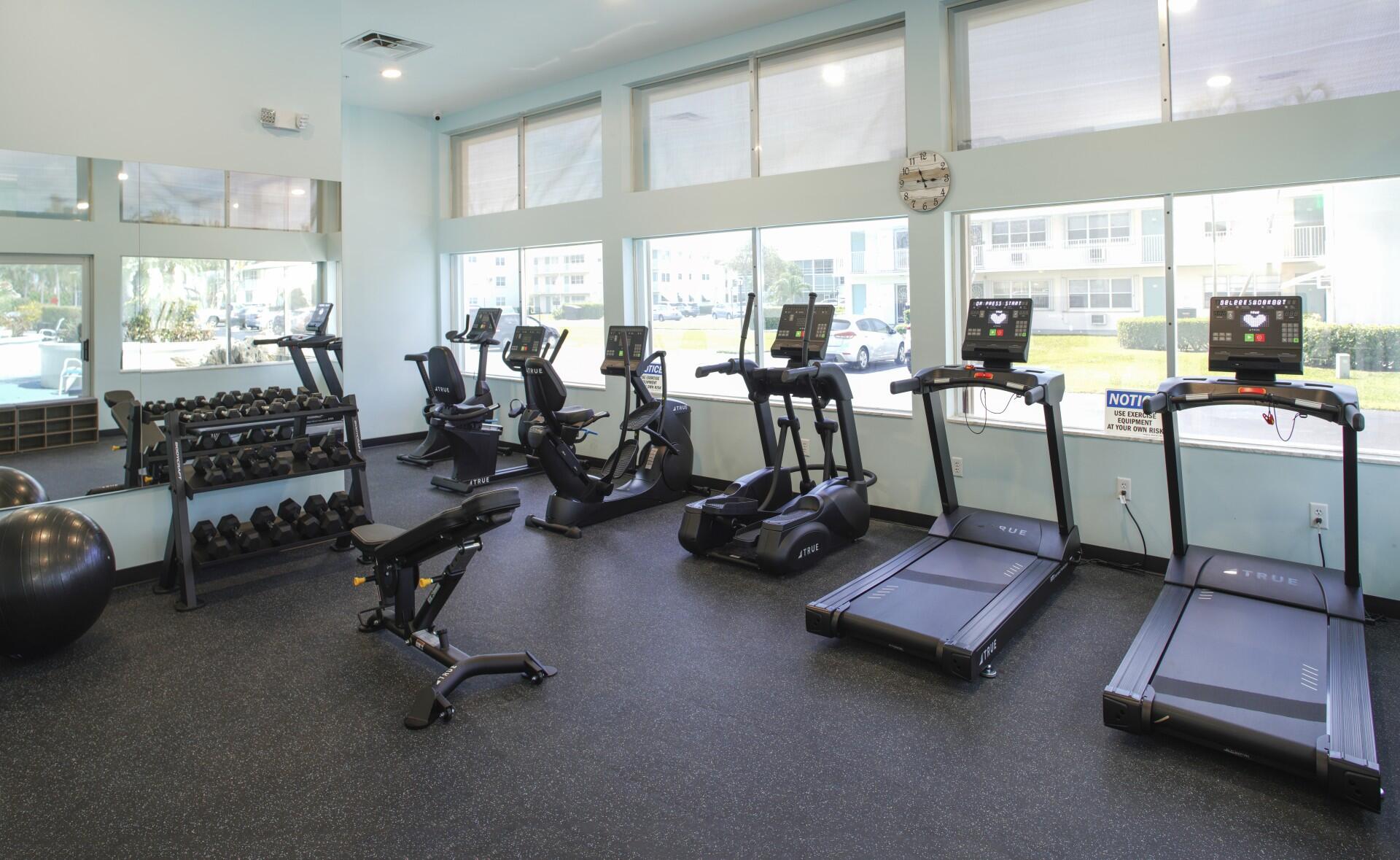 880 Horizon West, Unit 102 Boynton Beach, FL 33435 - Photo 29 of 34 a room with gym equipment and large window