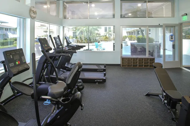 a room with gym equipment and a large window
