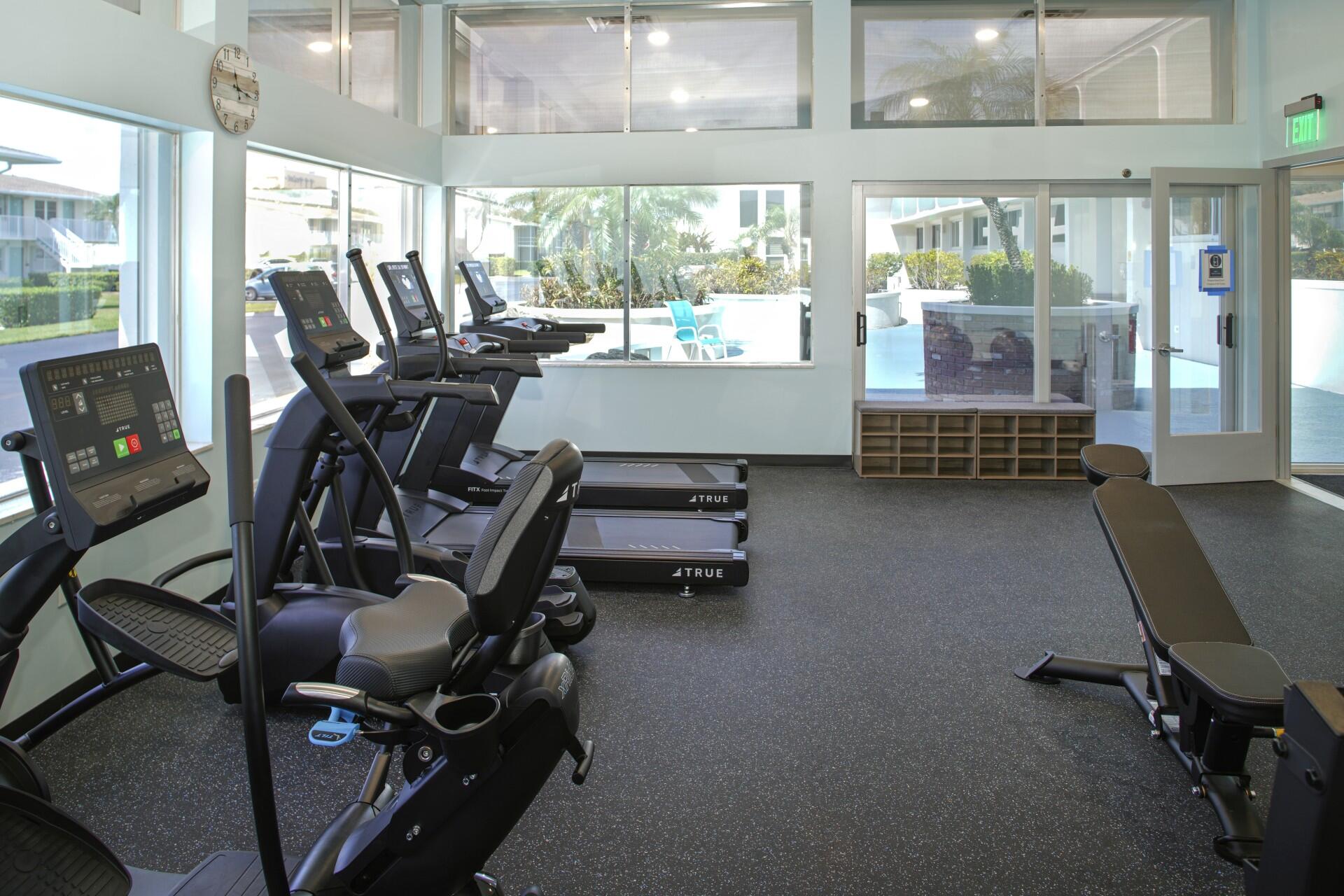 880 Horizon West, Unit 102 Boynton Beach, FL 33435 - Photo 30 of 34 a room with gym equipment and a large window