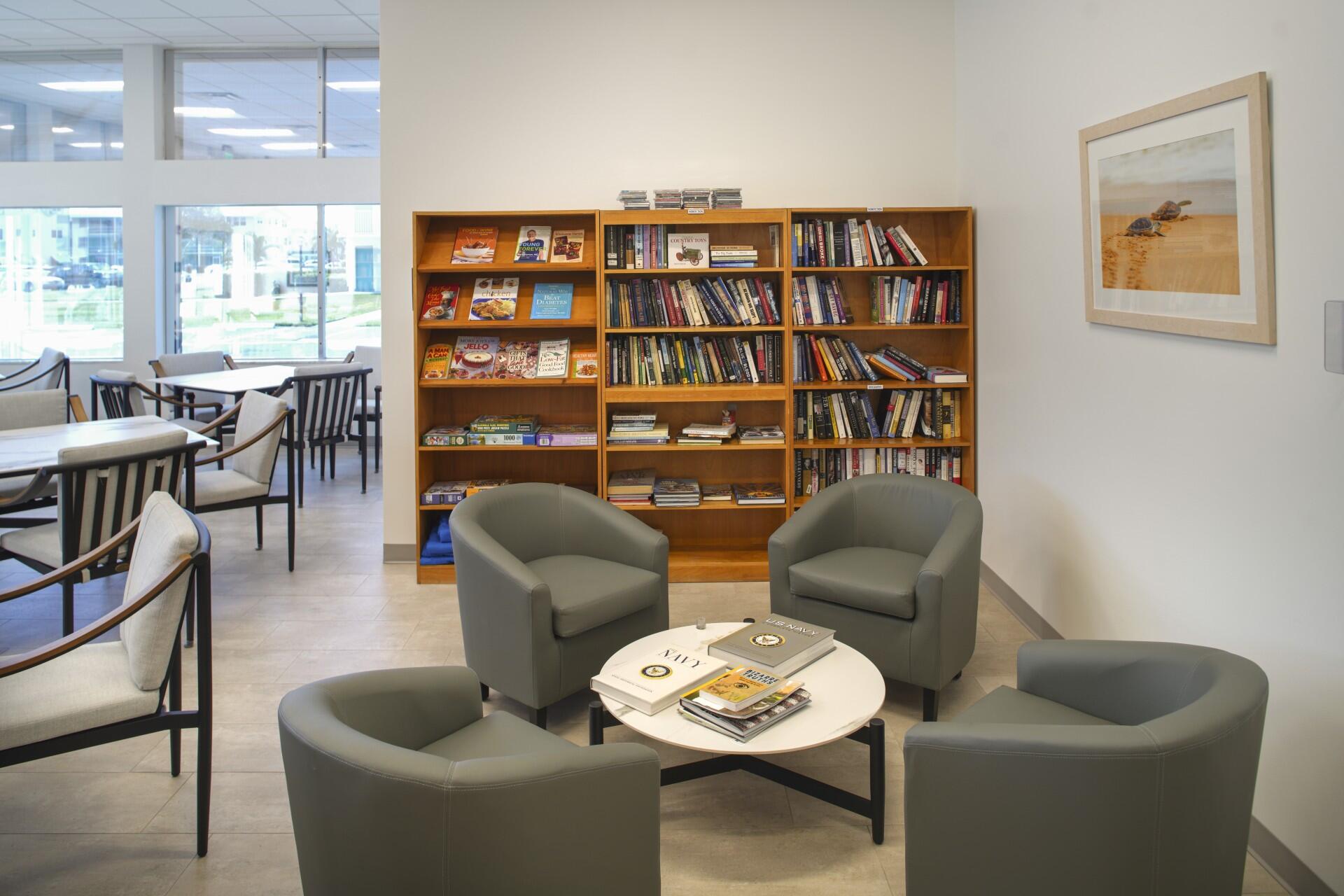 880 Horizon West, Unit 102 Boynton Beach, FL 33435 - Photo 32 of 34 a living room with furniture a bookshelf and a window