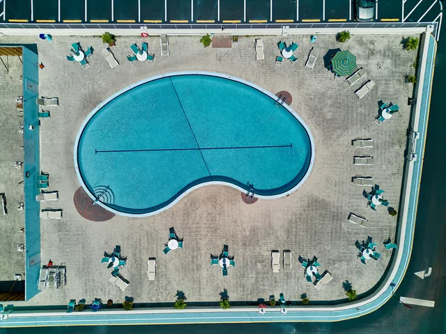 an aerial view of a swimming pool with a porch