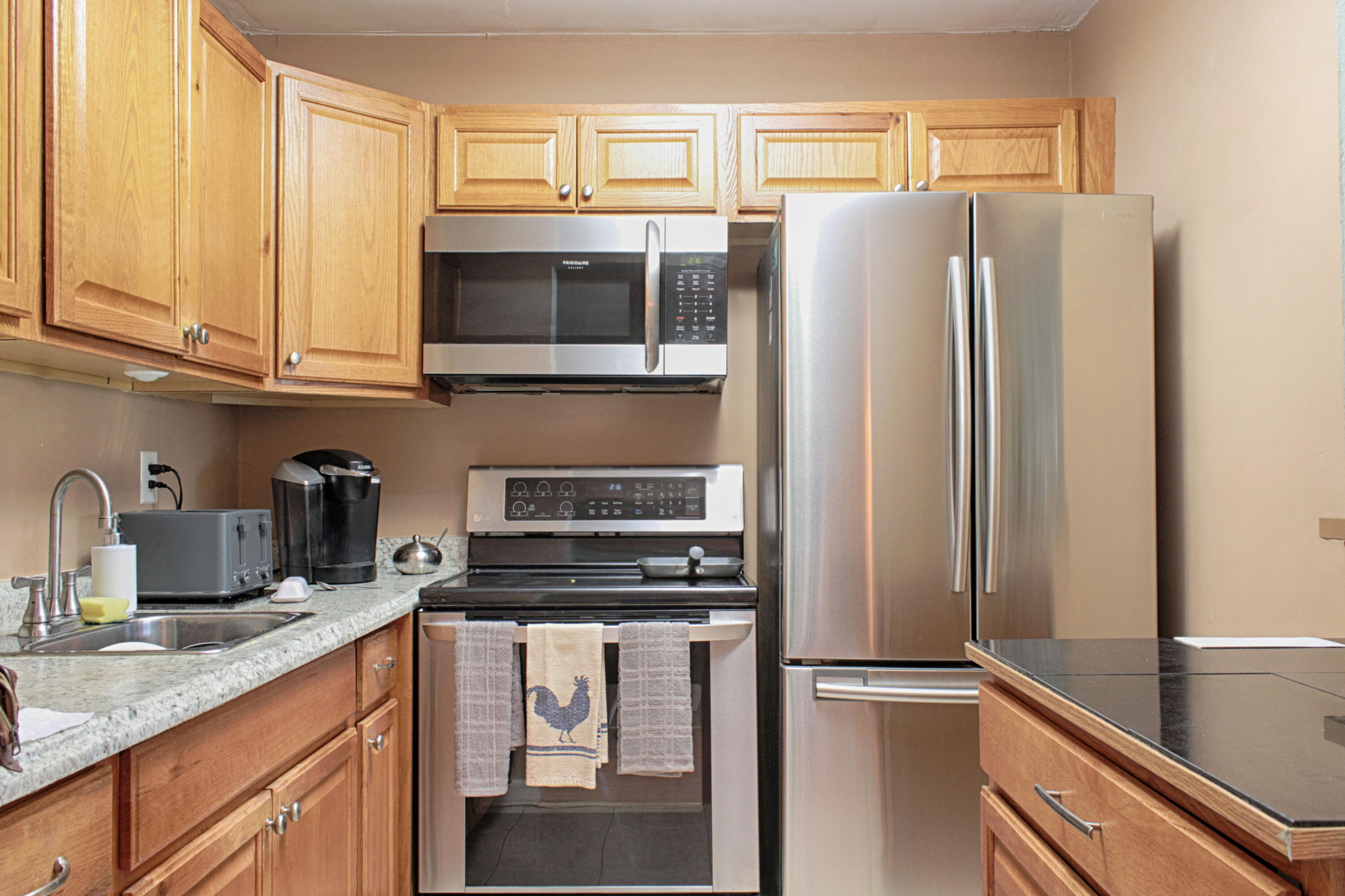 880 Horizon West, Unit 102 Boynton Beach, FL 33435 - Photo 7 of 34 a kitchen with stainless steel appliances a refrigerator and a sink