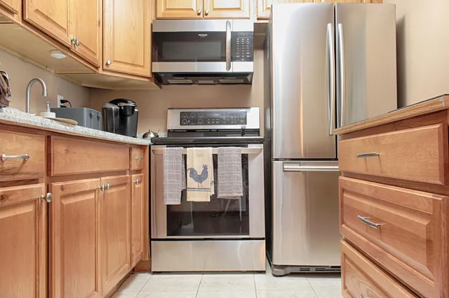a kitchen with stainless steel appliances a refrigerator and cabinets