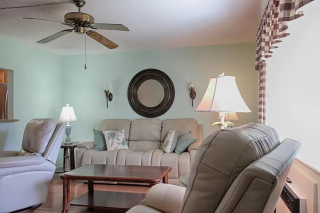 a living room with furniture and a lamp