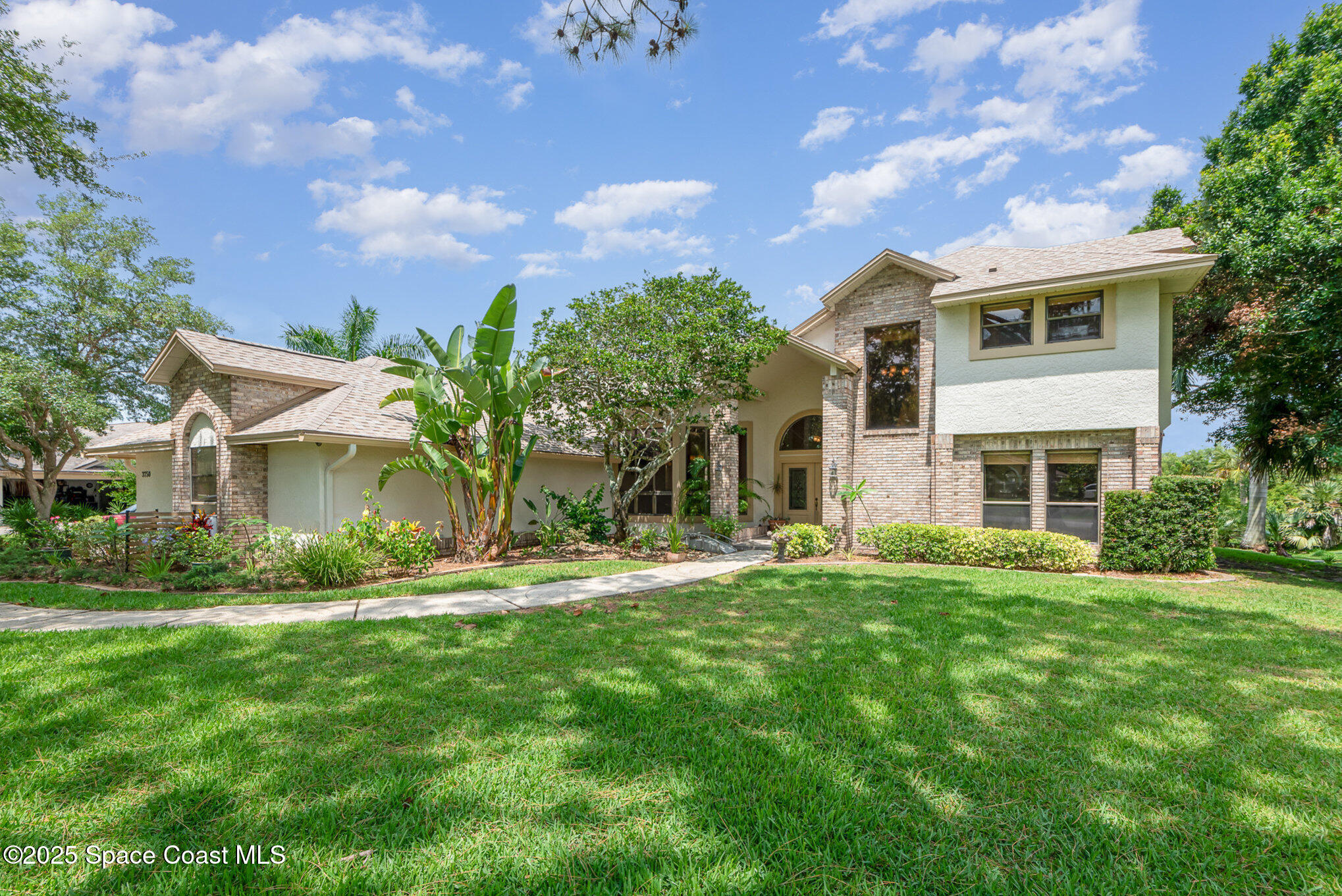 3750 Shady Run Road Melbourne, FL 32934 - Photo 1 of 50 a front view of a house with a yard