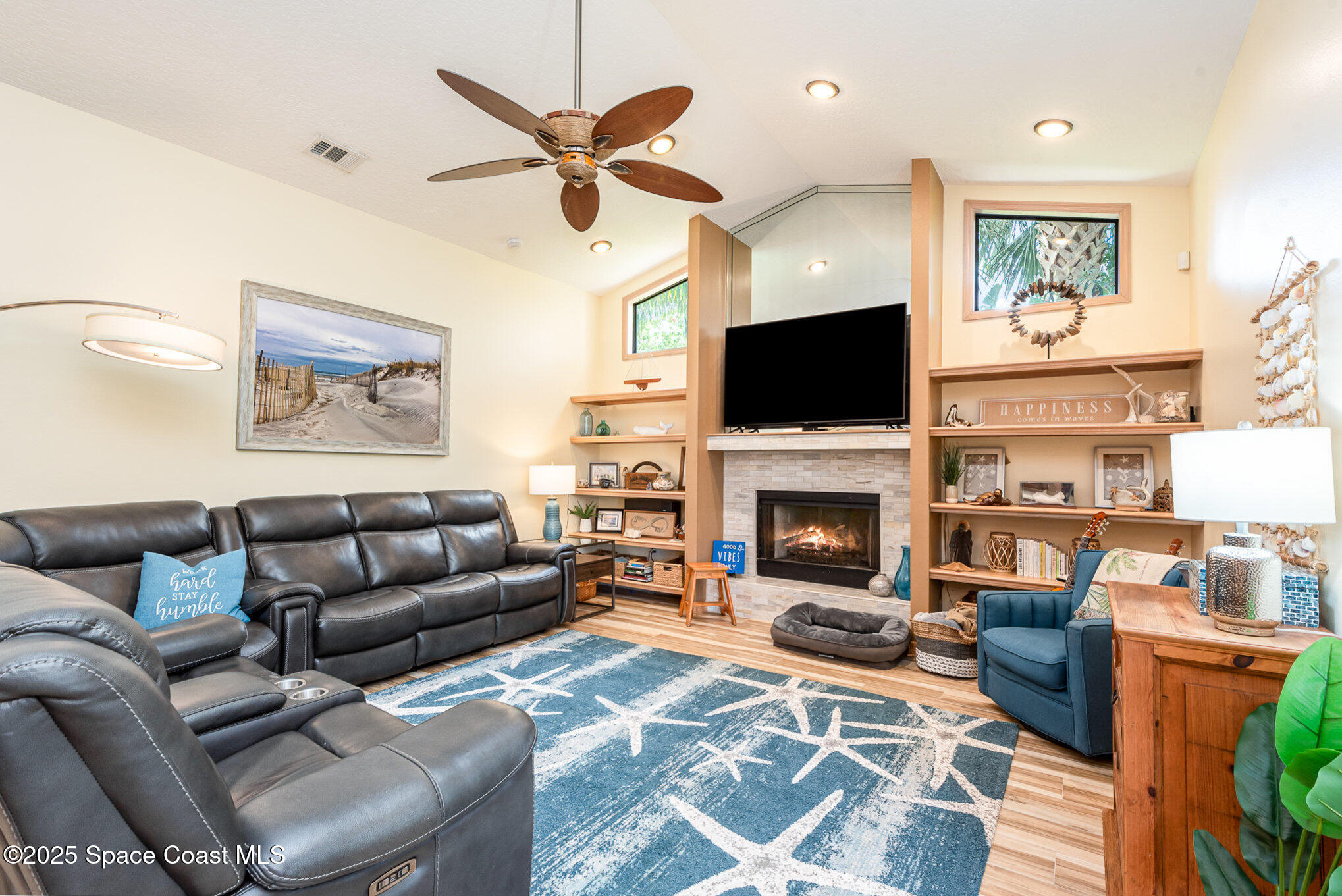 3750 Shady Run Road Melbourne, FL 32934 - Photo 13 of 50 a living room with furniture a fireplace and a flat screen tv