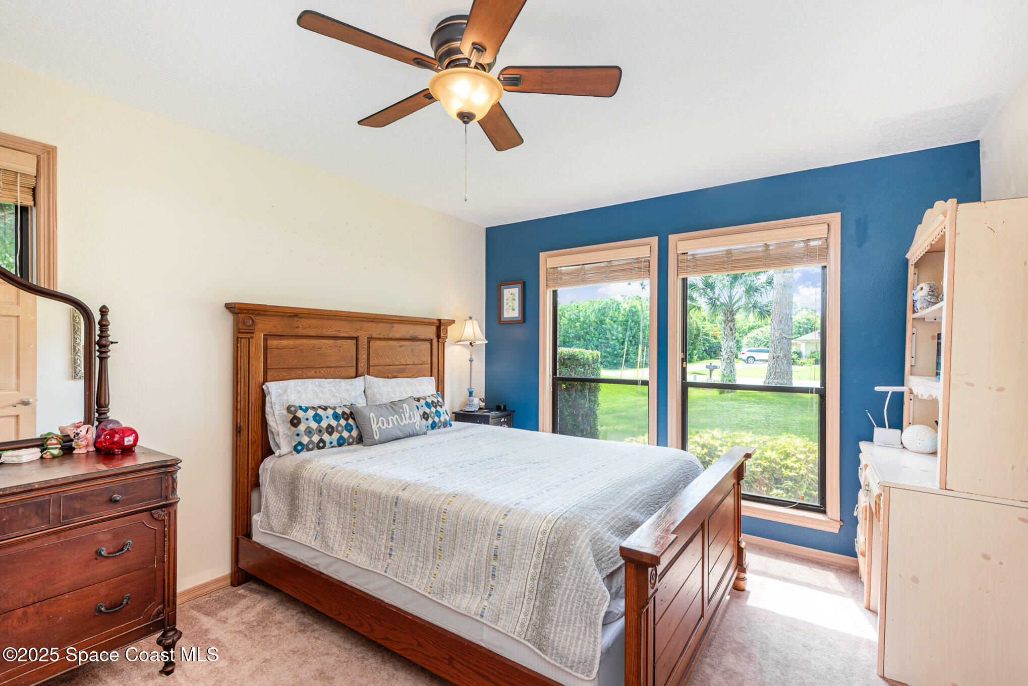 3750 Shady Run Road Melbourne, FL 32934 - Photo 24 of 50 a bedroom with a large bed and a large window