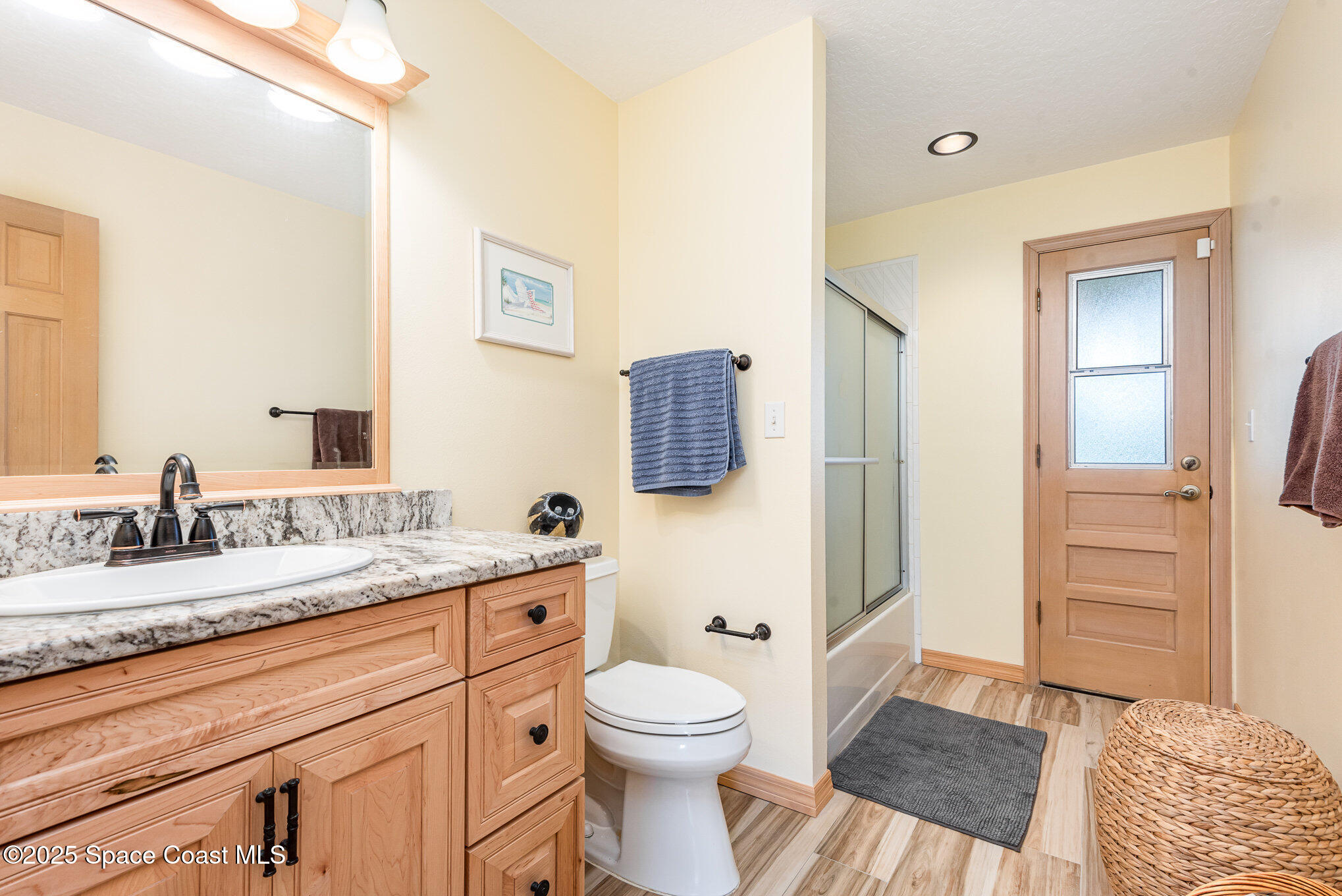 3750 Shady Run Road Melbourne, FL 32934 - Photo 26 of 50 a bathroom with a granite countertop sink toilet and shower