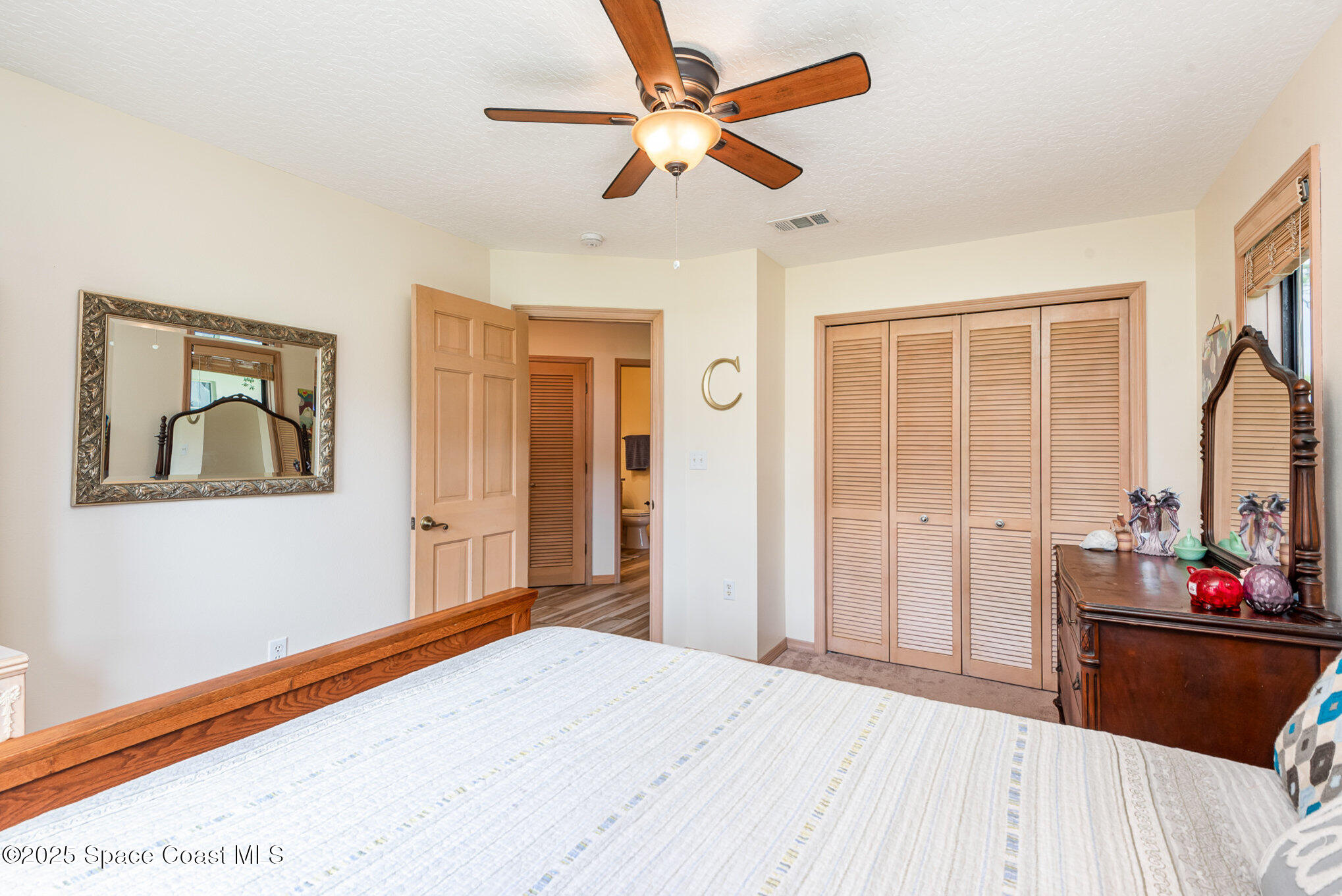 3750 Shady Run Road Melbourne, FL 32934 - Photo 36 of 50 a bedroom with a bed and a dresser