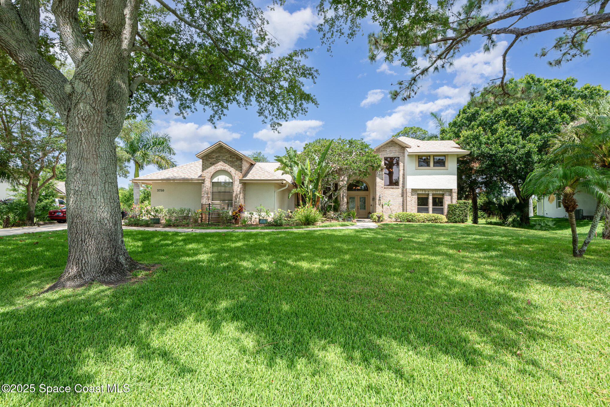 3750 Shady Run Road Melbourne, FL 32934 - Photo 38 of 50 a front view of a house with garden