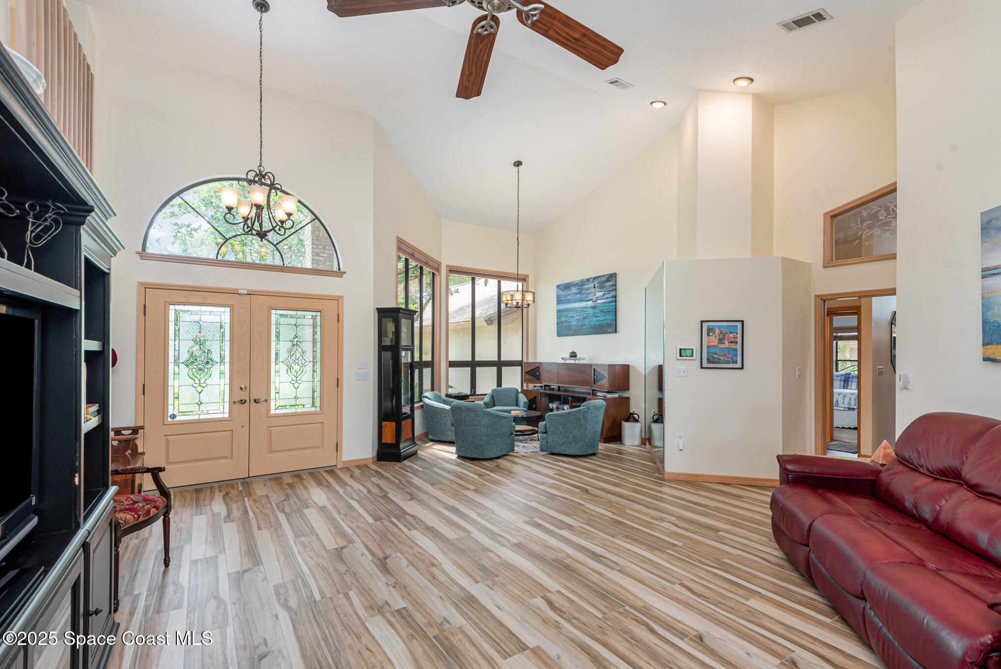 3750 Shady Run Road Melbourne, FL 32934 - Photo 4 of 50 a living room with furniture a window and wooden floor