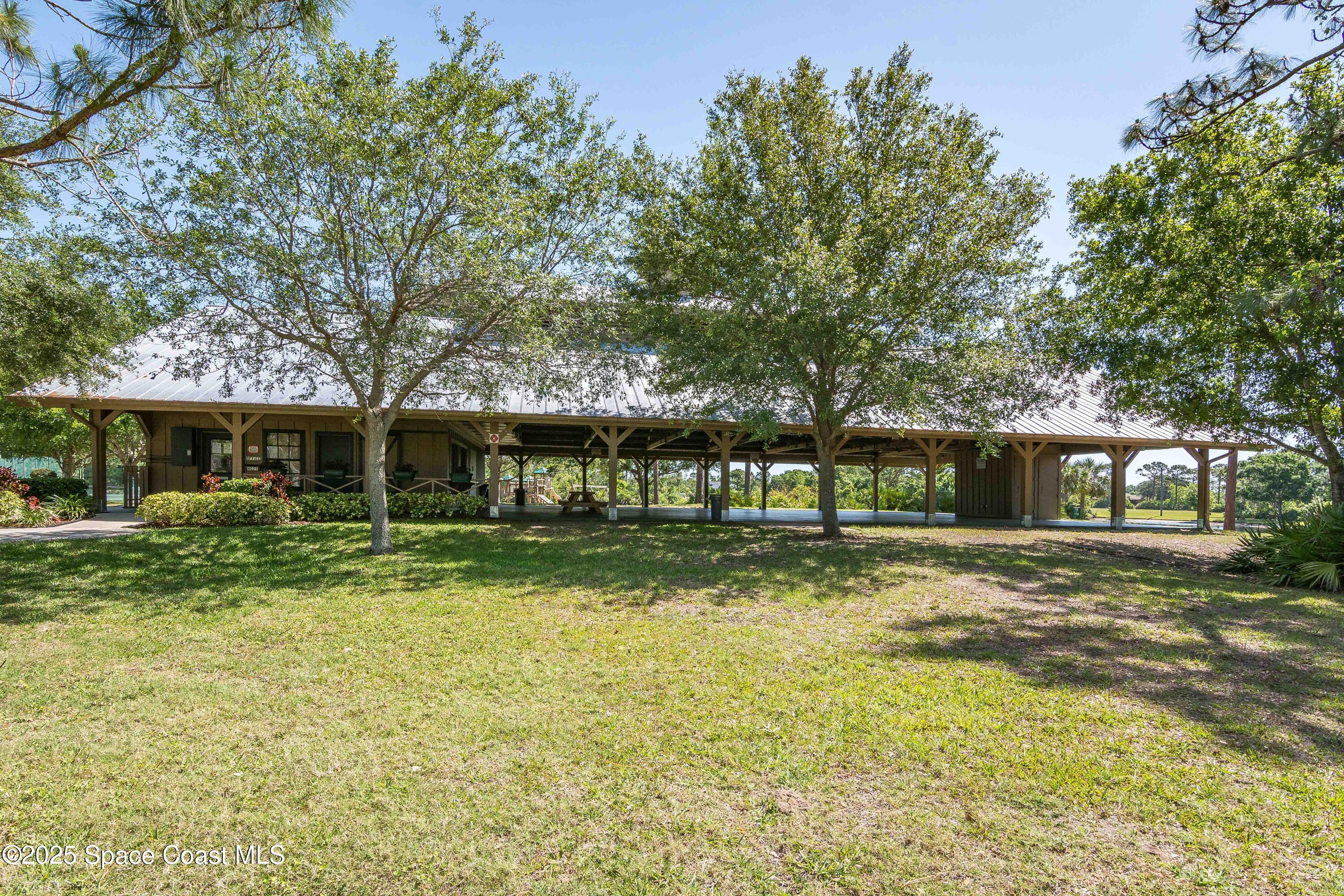 3750 Shady Run Road Melbourne, FL 32934 - Photo 50 of 50 a front view of a house with a garden