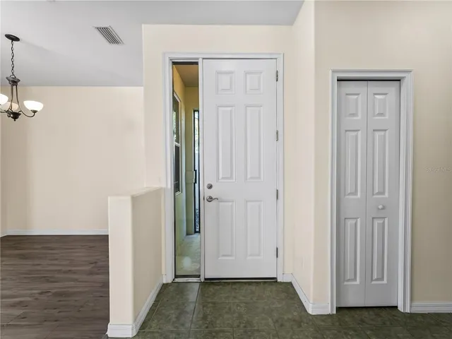 a view of a kitchen with wooden floor and a kitchen