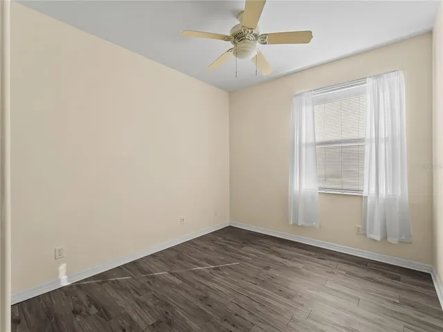 a view of a room with wooden floor