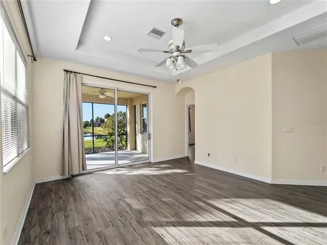 a view of a kitchen with furniture and wooden floor