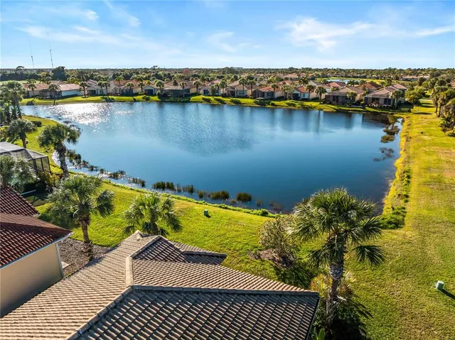 an aerial view of a house with a lake view