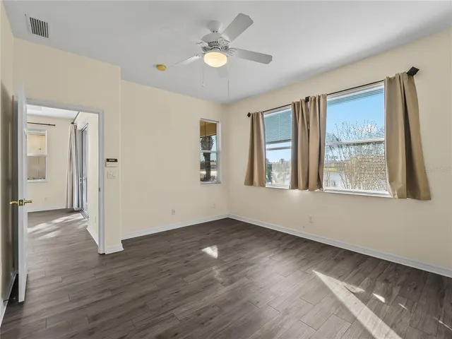 a view of an empty room with wooden floor