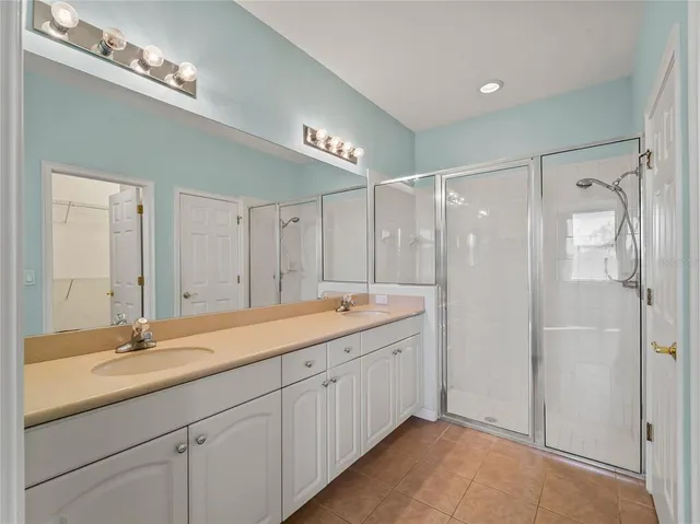 a bathroom with a granite countertop shower