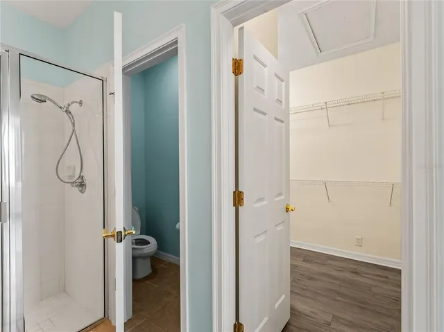 a spacious bathroom with a shower sink and mirror