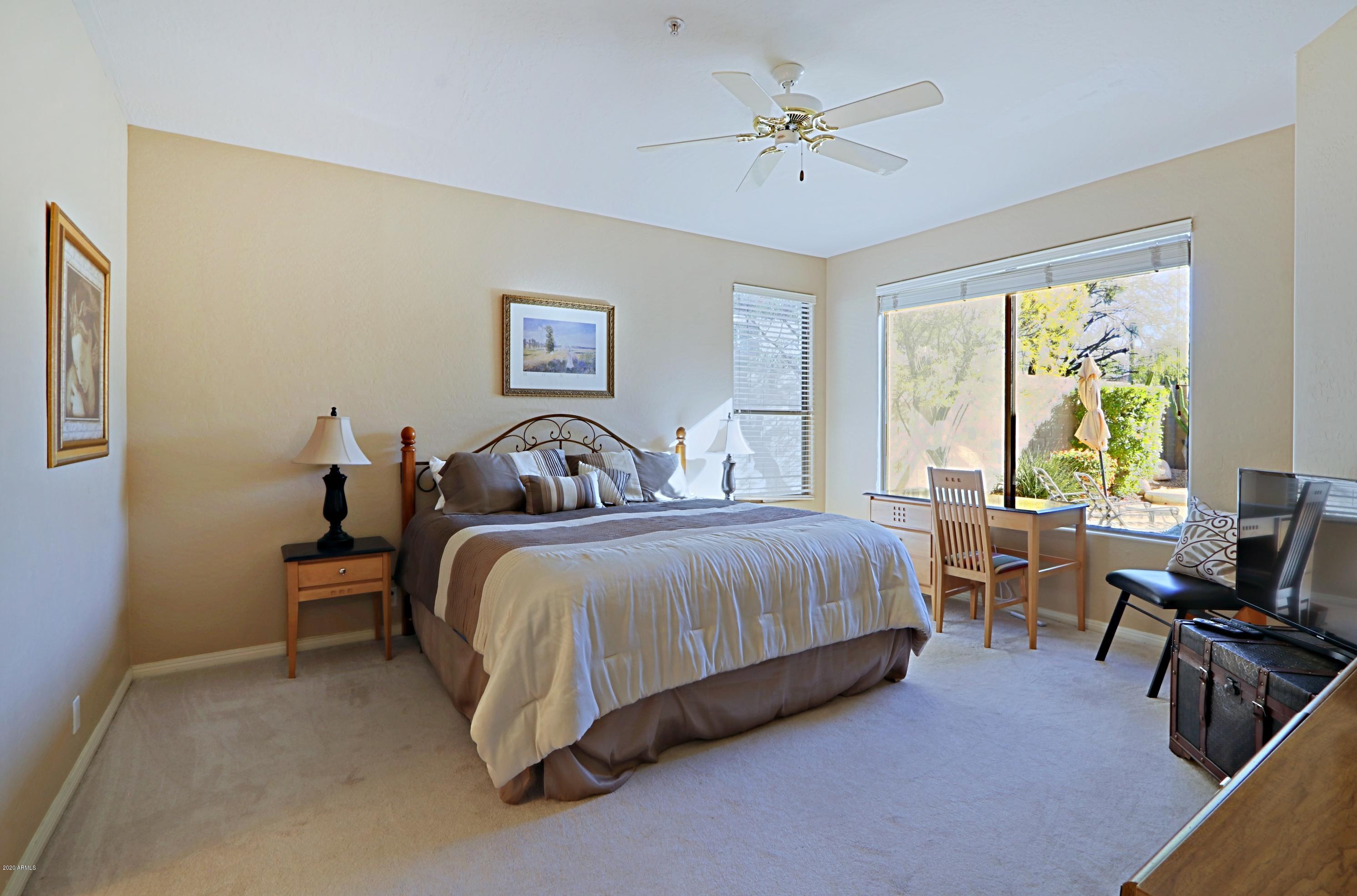 6803 East Eagle Feather Road Scottsdale, AZ 85266 - Photo 13 of 67 a spacious bedroom with a bed and a table in it