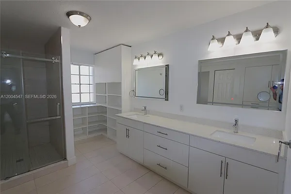 a bathroom with a double vanity sink and a mirror