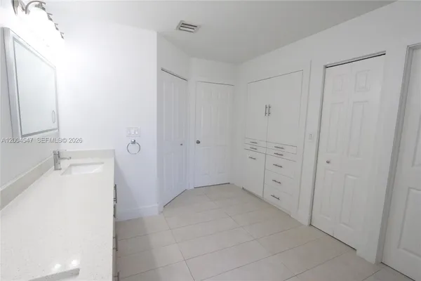 a view of a room with wooden floor and white walls