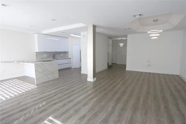 a kitchen with stainless steel appliances a refrigerator and a stove top oven