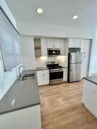 a kitchen with a sink a stove and refrigerator