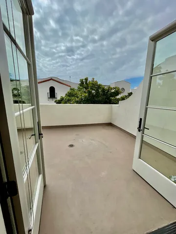 a view of balcony with wooden floor