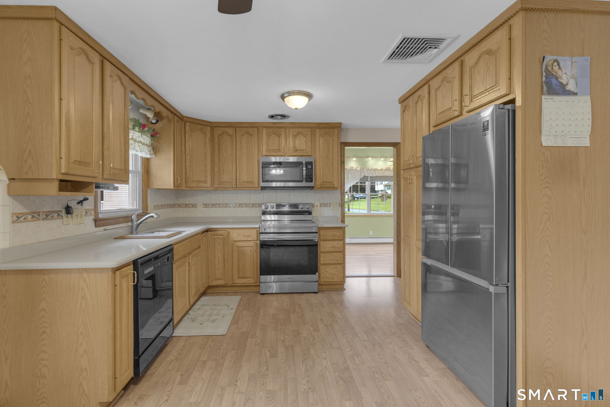 102 Wayne Lane Meriden, CT 06450 - Photo 9 of 36 a kitchen with stainless steel appliances granite countertop a stove a sink and a refrigerator