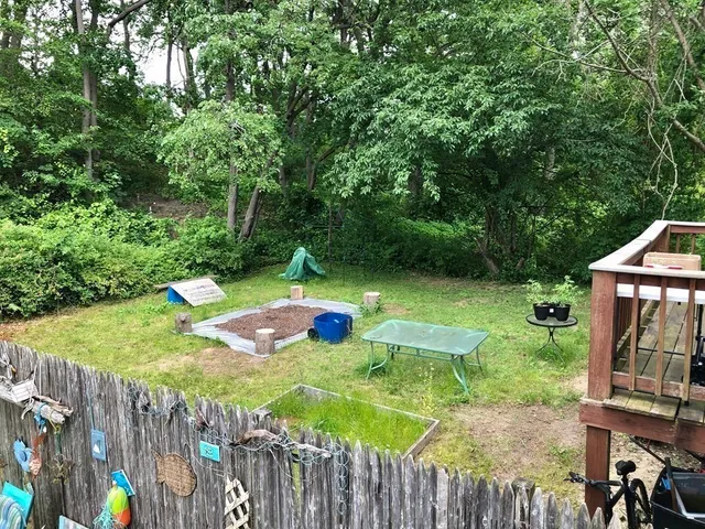 a view of a backyard with chairs and a slide
