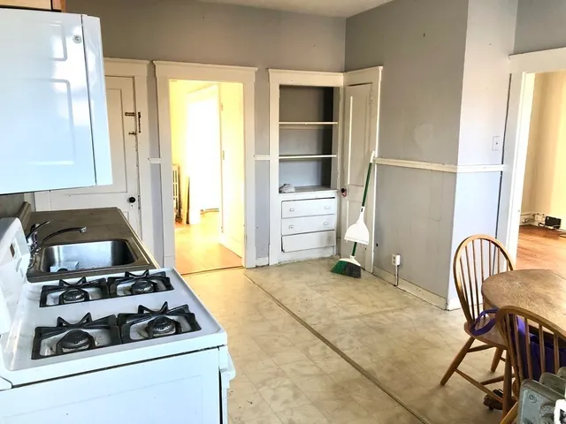 a kitchen with wooden cabinets and a stove top oven