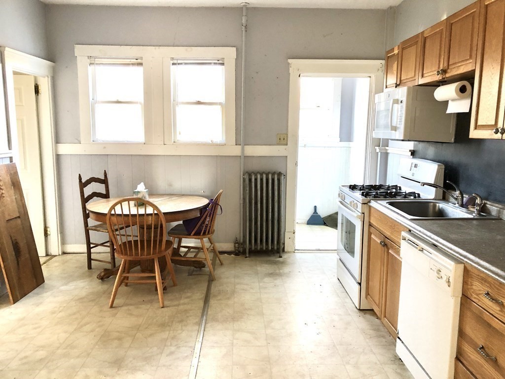 20-22 Hedge Road Plymouth, MA 02360 - Photo 5 of 29 a kitchen with a table chairs sink and cabinets