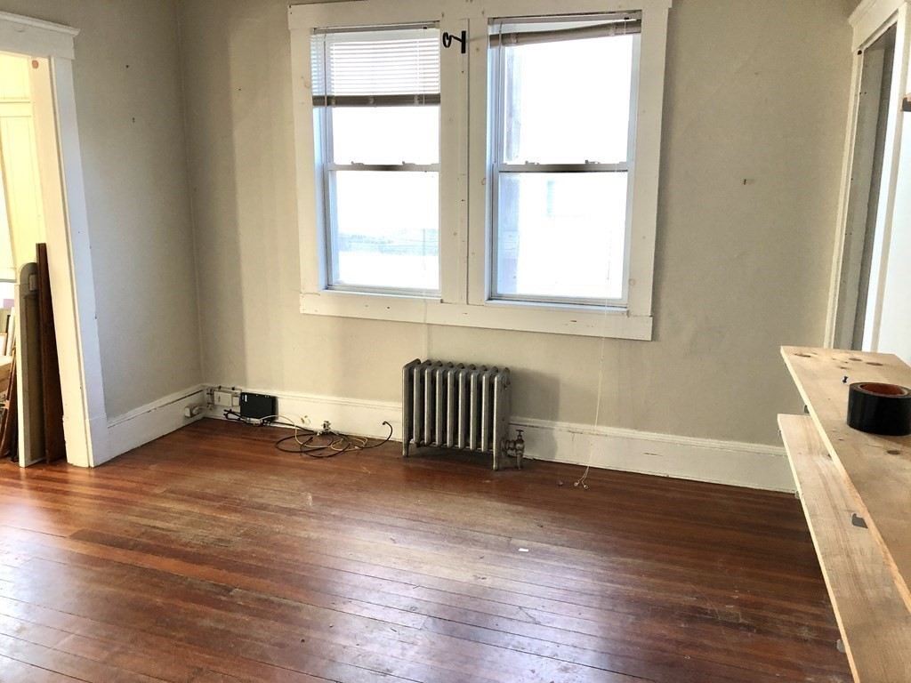 20-22 Hedge Road Plymouth, MA 02360 - Photo 6 of 29 a view of an empty room with wooden floor and a window