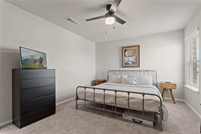 a bedroom with a bed and a table in it