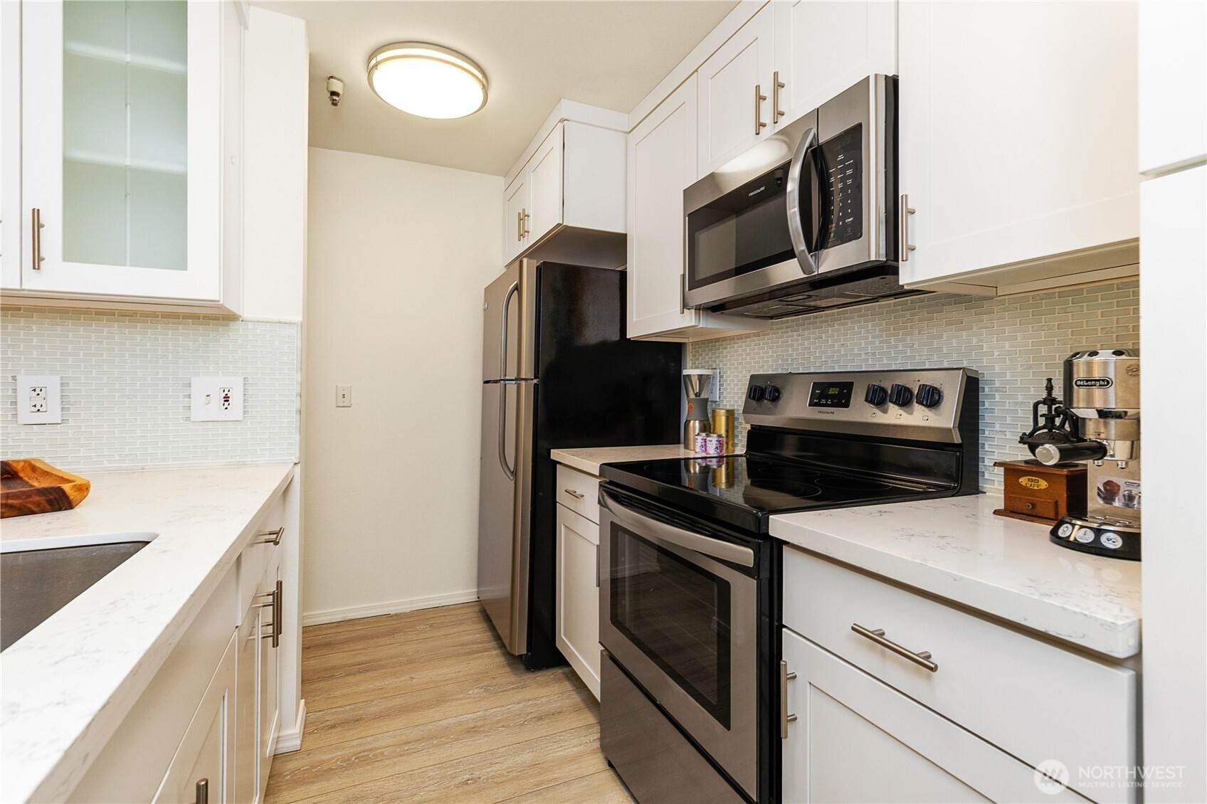 7453 Newcastle Golf Club Road, Unit G103 Newcastle, WA 98059 - Photo 13 of 37 a kitchen with stainless steel appliances a stove microwave and a refrigerator
