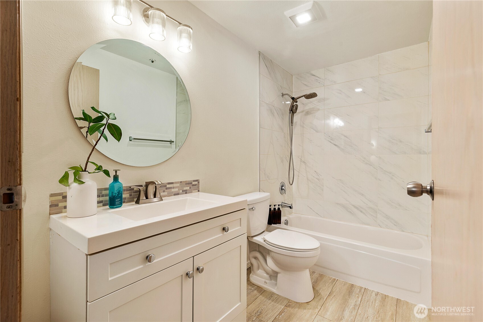 7453 Newcastle Golf Club Road, Unit G103 Newcastle, WA 98059 - Photo 19 of 37 a bathroom with a double vanity sink toilet mirror and bathtub