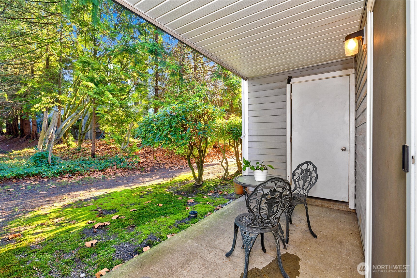 7453 Newcastle Golf Club Road, Unit G103 Newcastle, WA 98059 - Photo 23 of 37 a patio with table and chairs and potted plants